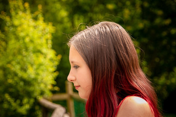Young dark haired girl relaxing outdoors