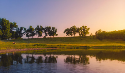 Fototapeta na wymiar Sunset on the edge of a lake in the country, Moldova, 2019