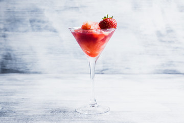 Frozen strawberry cocktail in martini glass. Selective focus.