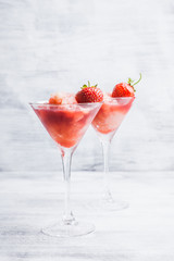 Frozen strawberry cocktail in martini glass. Selective focus.
