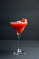 Frozen strawberry cocktail in martini glass. Selective focus.
