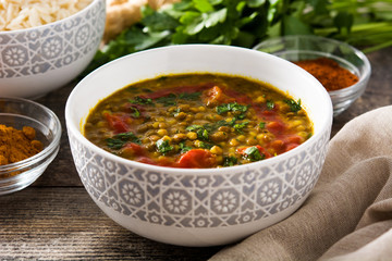Indian lentil soup dal (dhal) in a bowl on wooden table