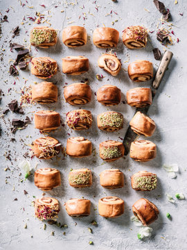 Cinnamon buns rolls with pistachio cake drissle organized flat lay