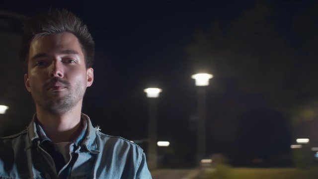 Point of view shot of young man while spinning on blurred background at night