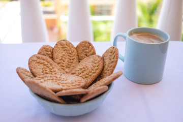 Breakfast or break outdoor on the balcony with coffe cup and whole grain biscuits. Healthy food and drink