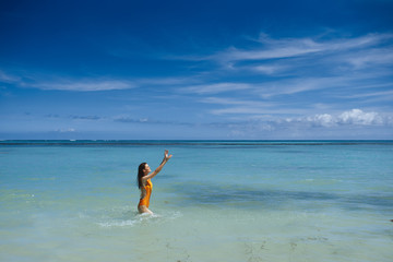 Fototapeta na wymiar woman jumping on the beach