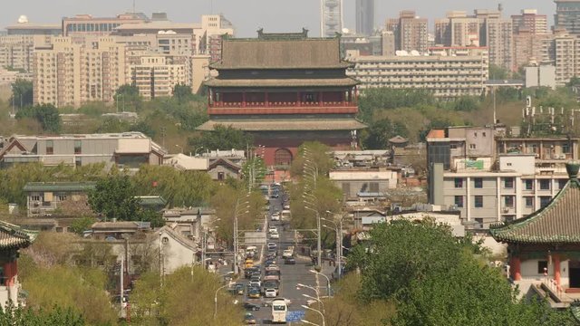 Beijing cityscape: road with traffic, old pagode and new buildings.