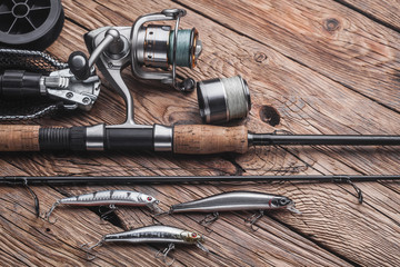 Fishing tackle for catching predatory fish. Wobblers, spinning, reel, fishing line on the wooden...