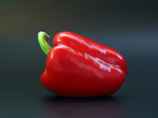 red sweet pepper on a contrasting black background