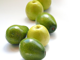 green apples and an avocado on a white background.