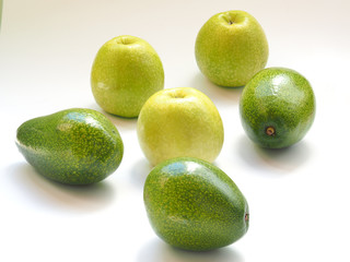 green apples and an avocado on a white background.