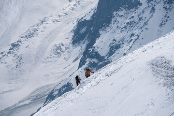 Naklejka na ściany i meble Moutaineers climbing of snowy mountain
