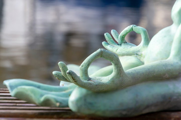 Close up hand. Stone frog doing yoga outdoor. Zen relax and relaxation yoga at the nature background. Healthy and Lifestyle Concept