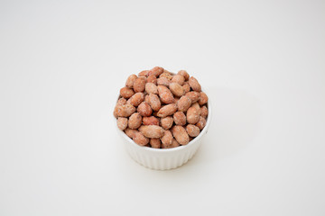 nuts in a bowl isolated on white background