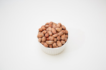 peanuts in a bowl isolated on white background