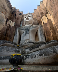 Fototapeta na wymiar huge 11 m wide and 15 m high seated Buddha in Wat Si Chum in famous Sukhothai Historical Park, a UNESCO World Heritage Site, the ancient 13th and 14th centuries capital of Sukhothai. Thailand