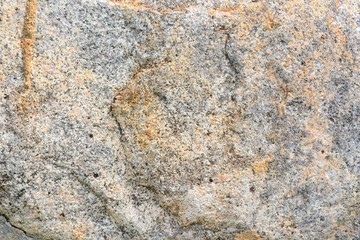 Natural stone background with textured surface. Pattern rocks with rough structure. Aging colorful mountain backdrop. Natural stone surface with empty space for image or text. Aging granite texture