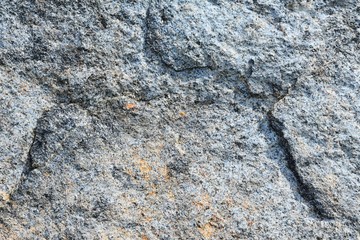 Natural stone background with textured surface. Pattern rocks with rough structure. Aging colorful mountain backdrop. Natural stone surface with empty space for image or text. Aging granite texture