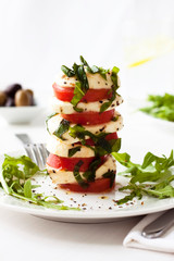  A fresh tomato and mozzarella appetizer, with fresh basil. 