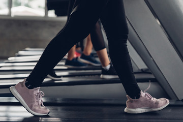 Close up shoe and legs. Asian women running in a gym on a treadmill.