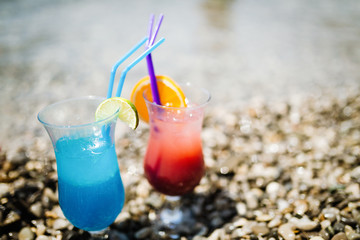 Two tropical fresh juices, cocktails on beach