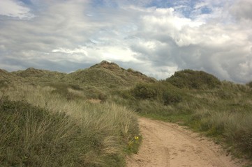 road in hills with clouds