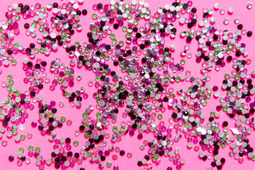 Gold multi-colored sparkles on a pink pastel trendy background. Festive christmas background