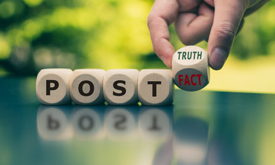 Hand turns a cube and changes the expression 