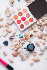 Fototapeta na wymiar fashion summer coral eye palettes with natural shells and gemstones around background. close up