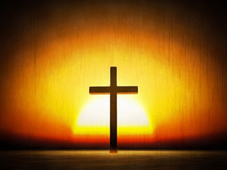 Naklejka premium Cross on a sunset