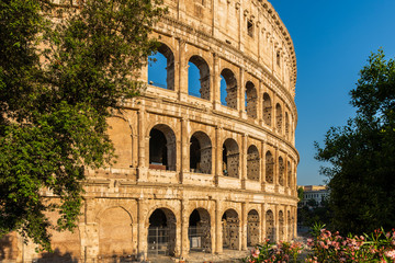 Ancient amphitheatre in the city centre of Rome known as Coliseum or Colosseum at sunrise, Italy