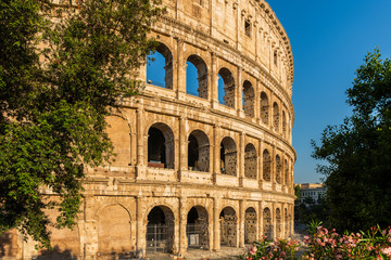 Ancient amphitheatre in the city centre of Rome known as Coliseum or Colosseum at sunrise, Italy