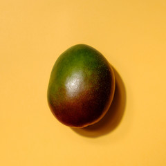 Creative layout made of mango on yellow colored background, minimal flat lay style. Food concept. Colorful fruit pattern.