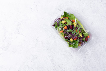 fresh healthy diet lunch box with vegetable salad on table background. free text space for diet menu.
