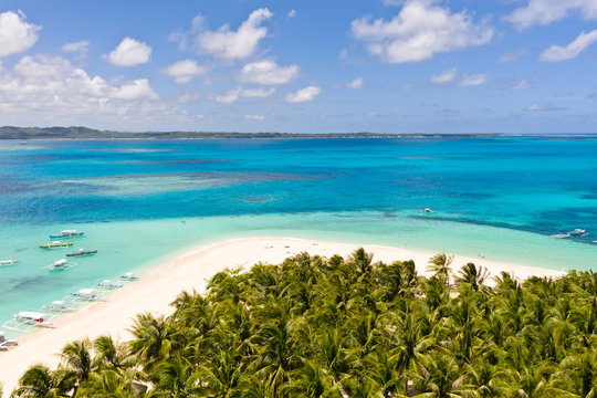 Seascape with a beautiful island. Daco island, Philippines. Tropical island with a white sandy beach for tourists. Island to relax.