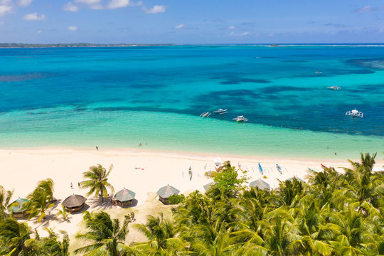 Beautiful tropical island in sunny weather, view from above. Daco island, Philippines. White sandy beach and turquoise lagoon.