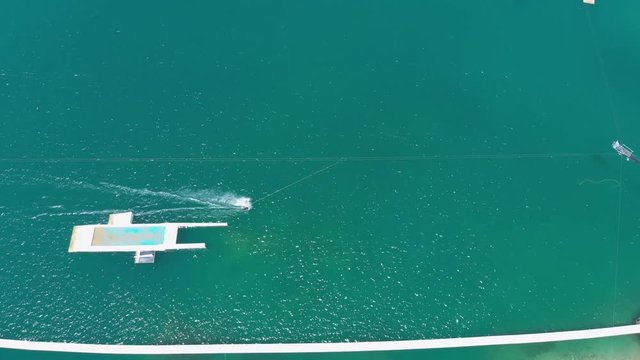 Aerial drone traking one person riding a wakeboard