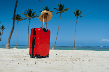 beach with luggage and umbrella on beach