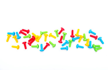 Colorful toy bolts. Construction toys. Background of the screws. Boltiks. Plastic toy