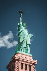 Fototapeta premium Geometric Front View of the Statue of Liberty with cloud on blue sky background