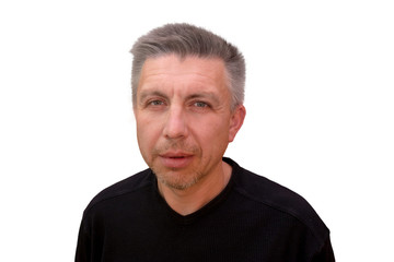 Obraz premium Guy looks into camera and squints. Isolated full faced portrait on white background. Emotion and gesture of middle aged unshaven shaggy man in black t-shirt. Angry face and aggressive view