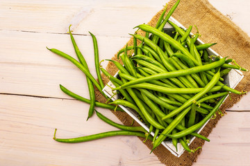 Phaseolus vulgaris, green common bean or kidney bean in wooden box