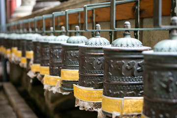 drums with buddhist mantras on open street. Temple, religion, deities, pray