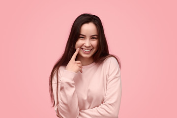 Cheerful teenager poking cheek