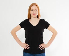 Fototapeta premium t-shirt design, happy people concept - smiling red hair woman in blank black t-shirt pointing her fingers at herself, red head girl tshirt mock up