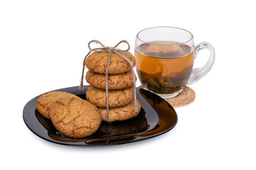 Green tea in a glass mug and homemade cookies. Isolated, cutout