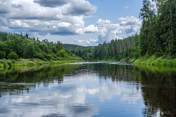 open view to the river of Gauja in Latvia with cloud reflections in water