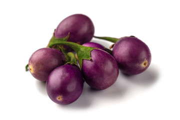 Group of baby purple eggplants on white background
