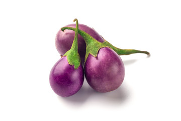 Group of baby purple eggplants on white background