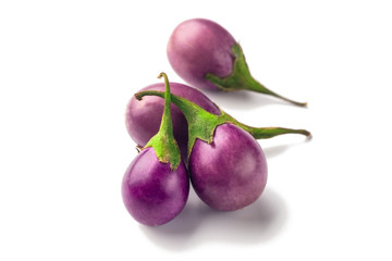 Group of baby purple eggplants on white background